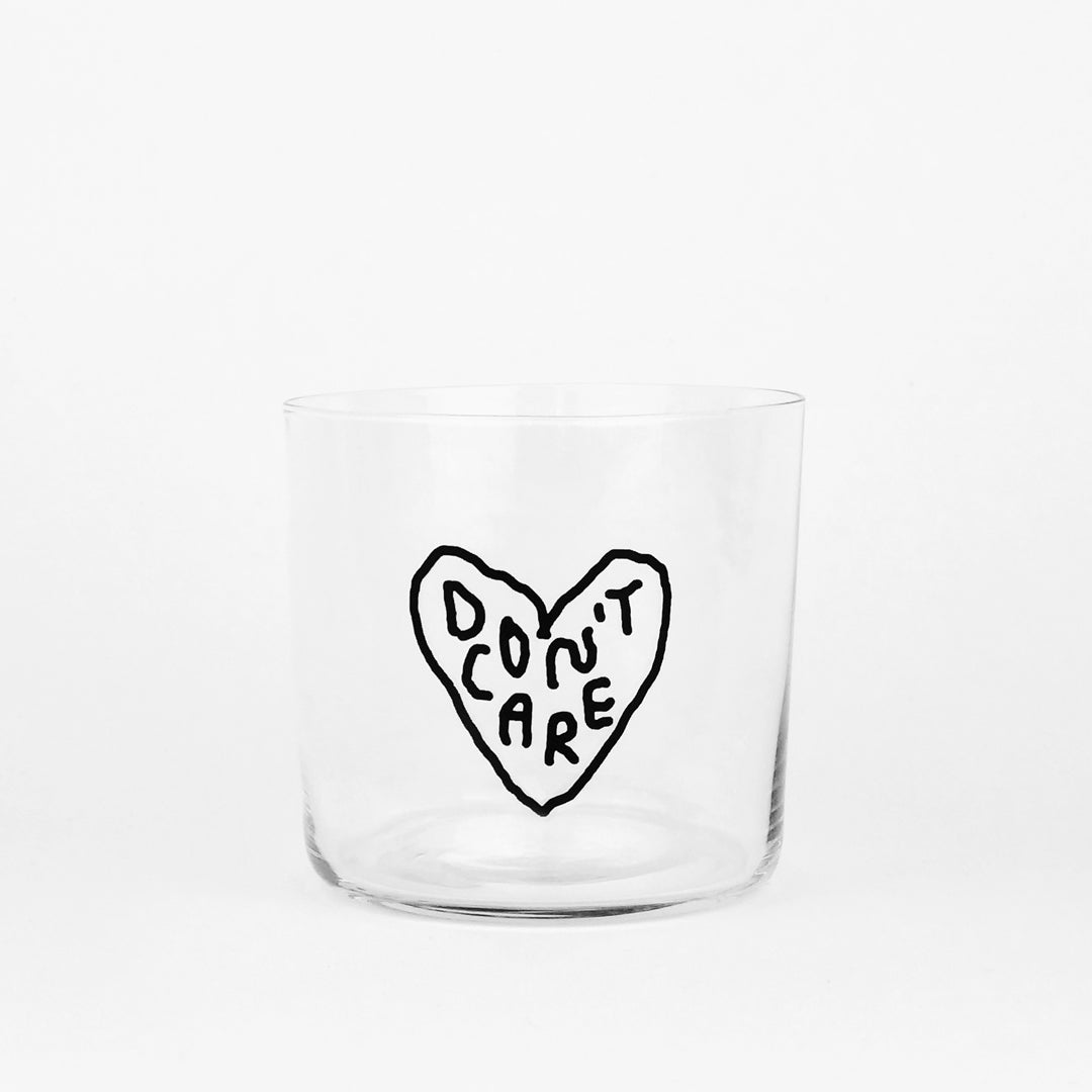 Designer Glas - Mittelgroß - mit schwarzem Spruch "Don't Caer" in einer Herzform auf der Front. Weißer Hintergrund.
