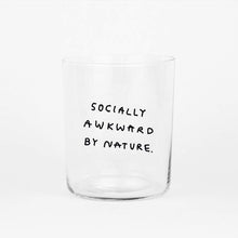 Großes Designer-Trinkglas mit sehr dünnen Glaswänden und einer schwarzen, einfarbigen Illustration auf der Vorderseite. Das Motiv auf dem Glas ist eine Handschrift in Schwarz in der geschrieben ist SOCIALLY AWKWARD BY NATURE auf weißem Hintergrund.