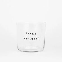 Medium Designer-Trinkglas mit sehr dünnen Glaswänden und einer schwarzen, einfarbigen Illustration auf der Vorderseite. Das Motiv zeigt eine Typografie in der geschrieben ist SORRY NOT SORRY auf weißem Hintergrund.